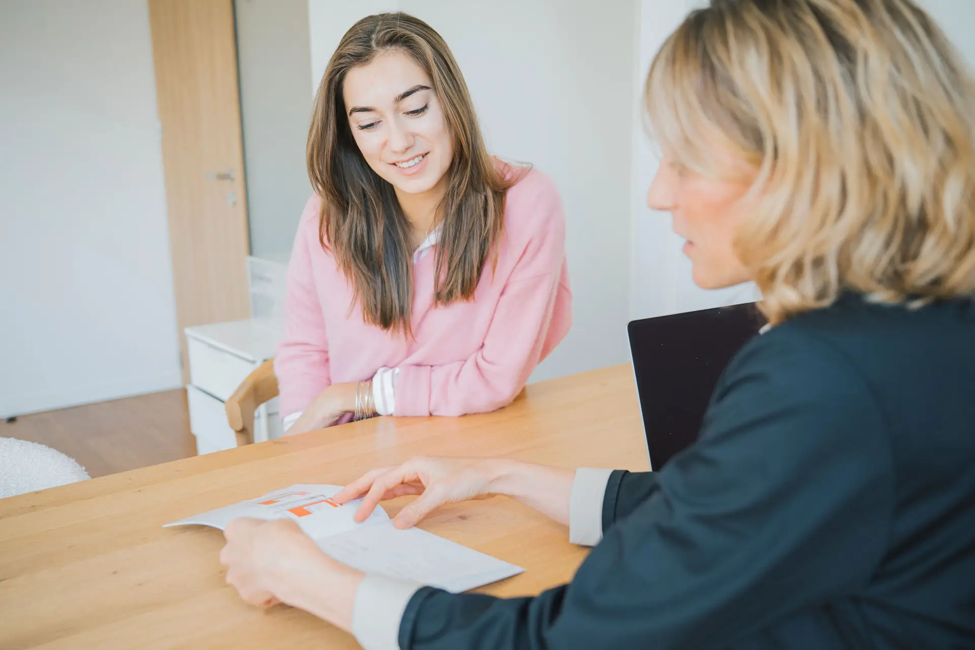 Deux femmes discutent d’un document à un bureau